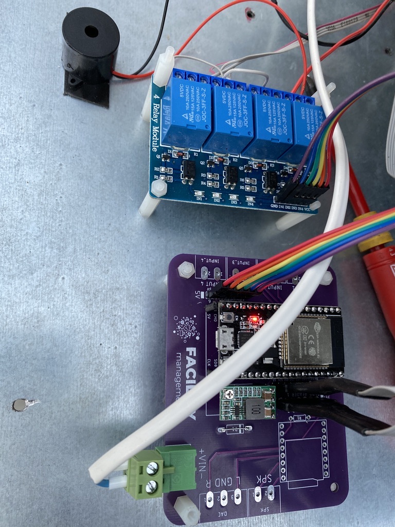 Prototype inside the metal enclosure: purple PCB, relay module and wiring