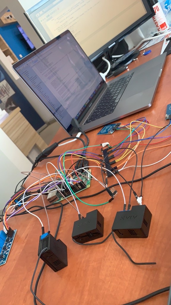 Sensor data logger prototype on a desk, with sensors, wiring and a laptop